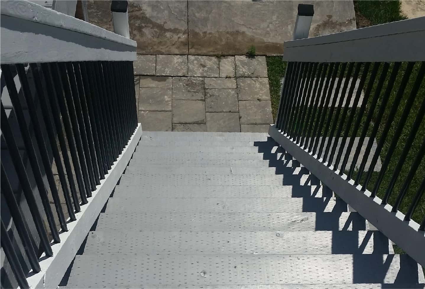 light grey painted deck stairs with wood and black railing
