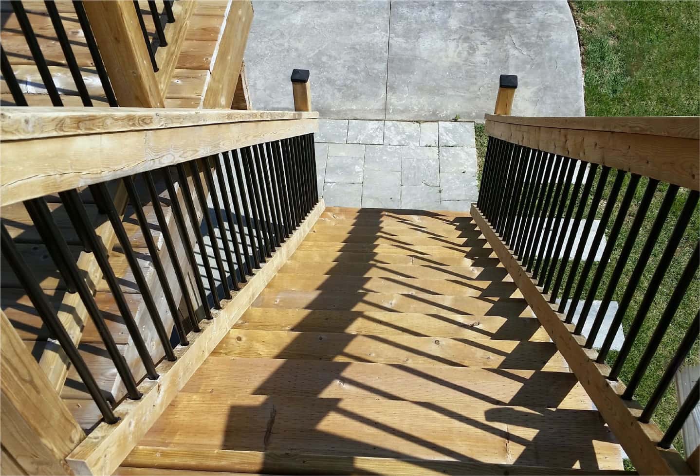 wood deck stairs with wood and black railing