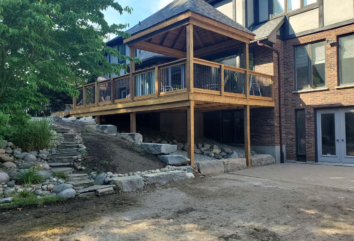 renovation of wood deck with railing, bench and gazebo in progress