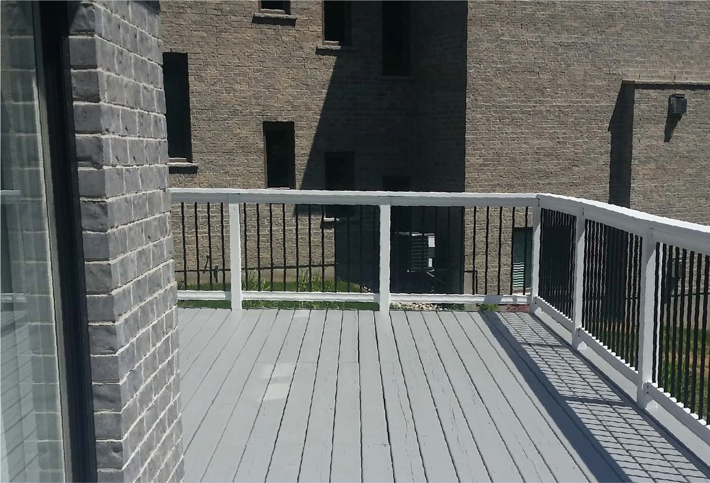 light grey painted deck with wood and black railing
