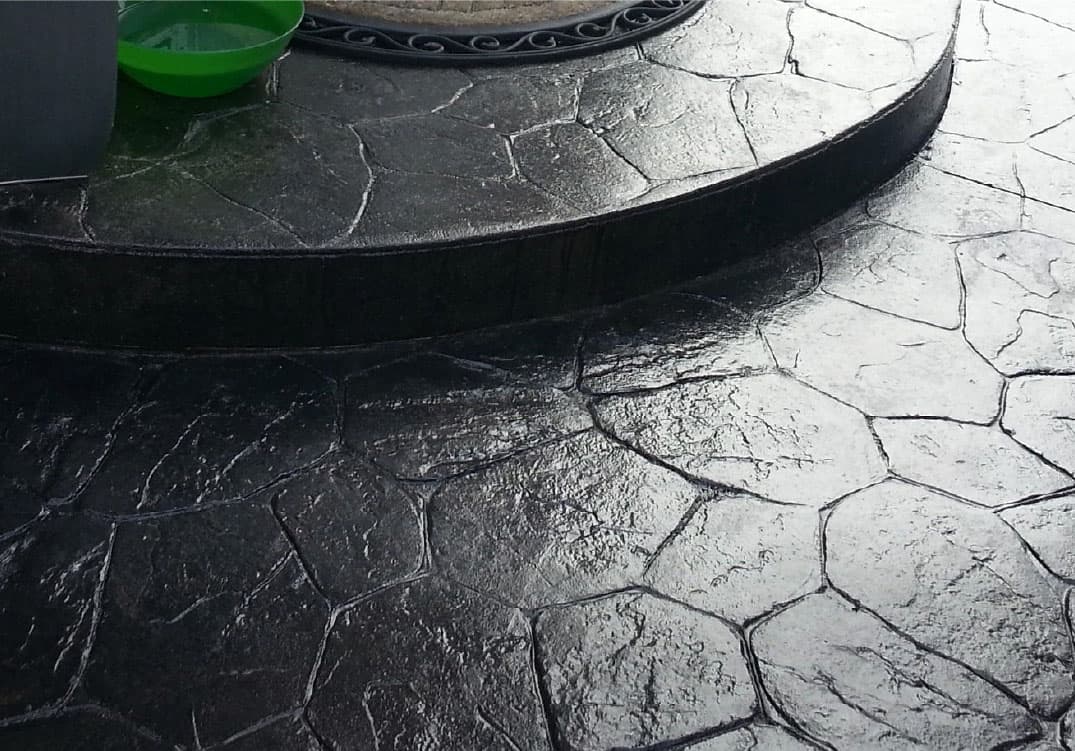 stone step of house and patio with stone tiles stained black