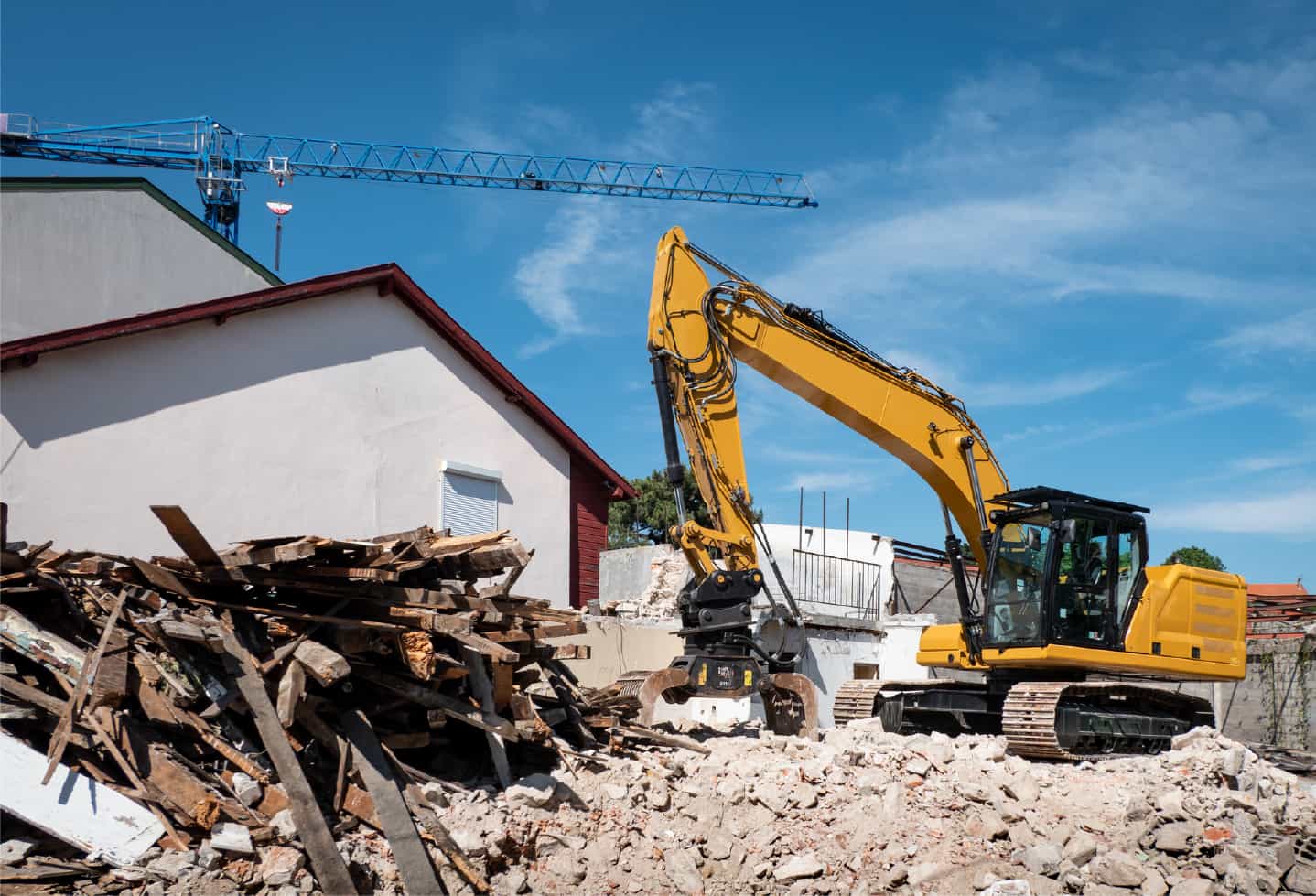 crane excavator at house demolition site