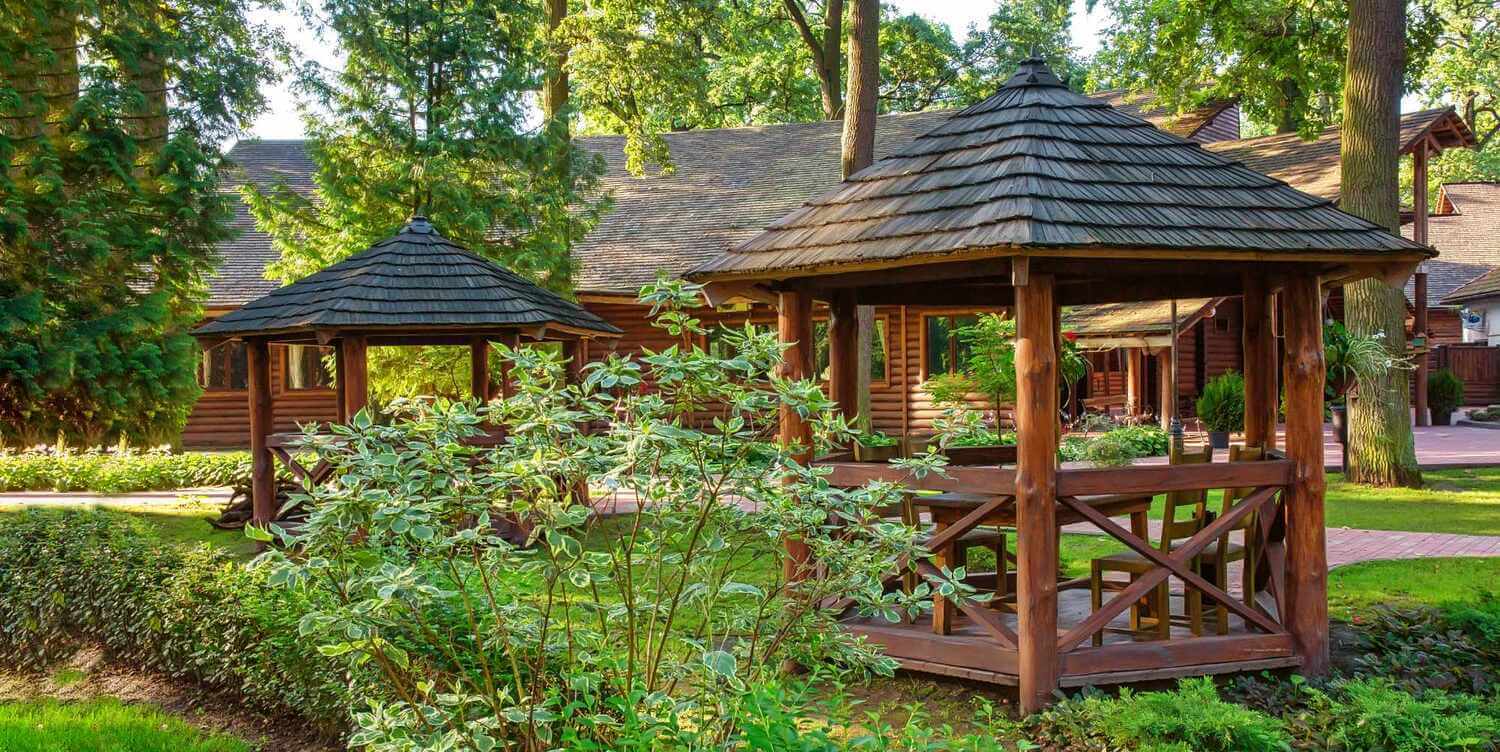 two wood gazebos outdoors backyard