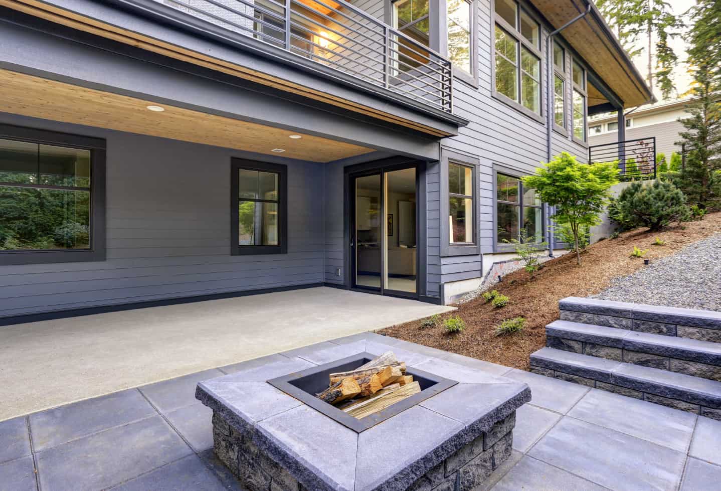 cement concrete covered patio with tiled patio area in backyard