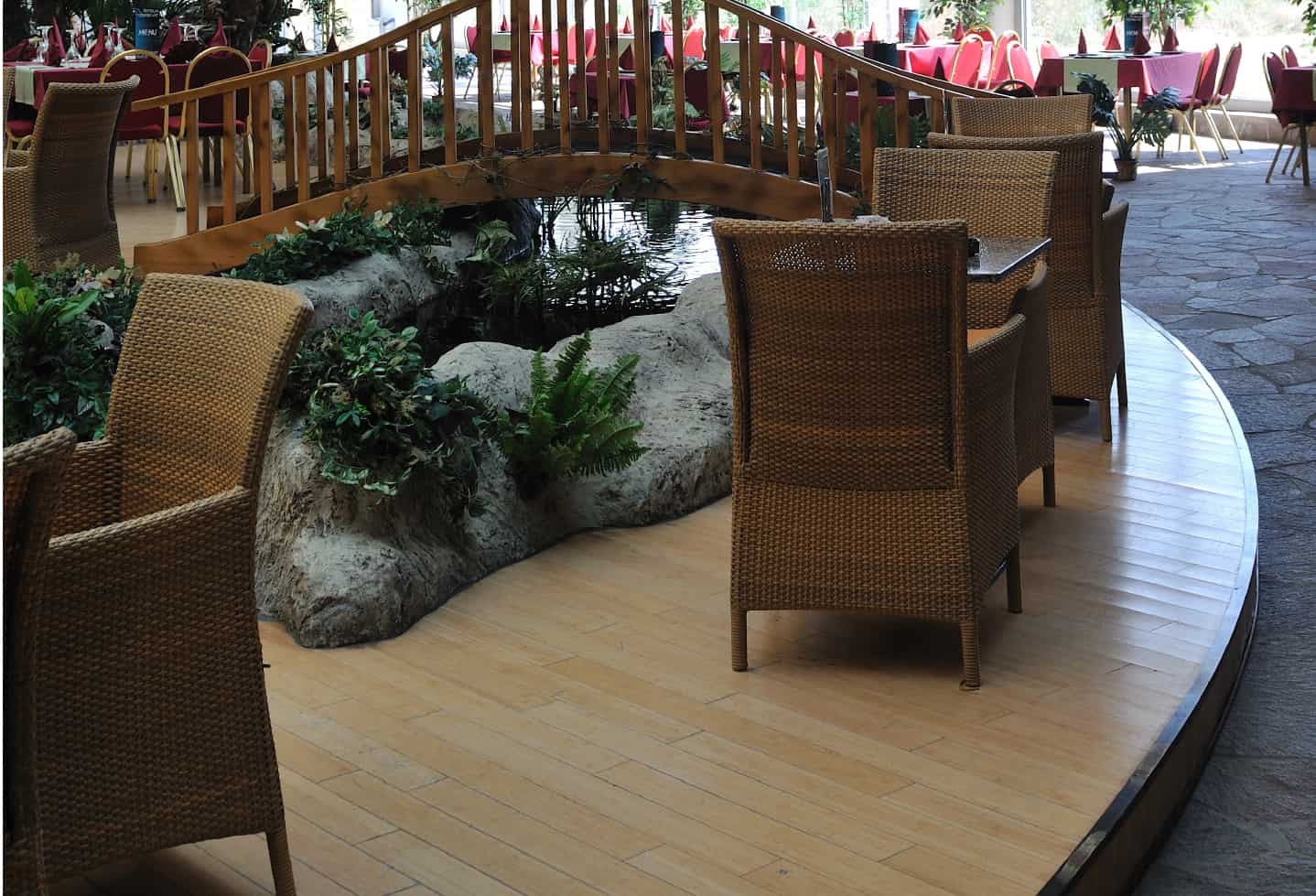 indoor pond with rocks and plants inside restaurant