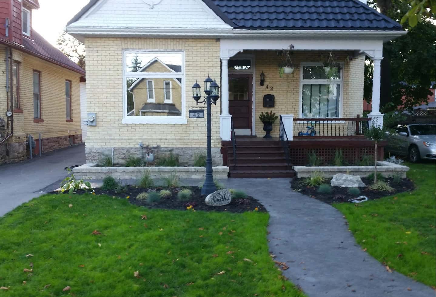 small house with newly install sod grass lawn and plants and trees