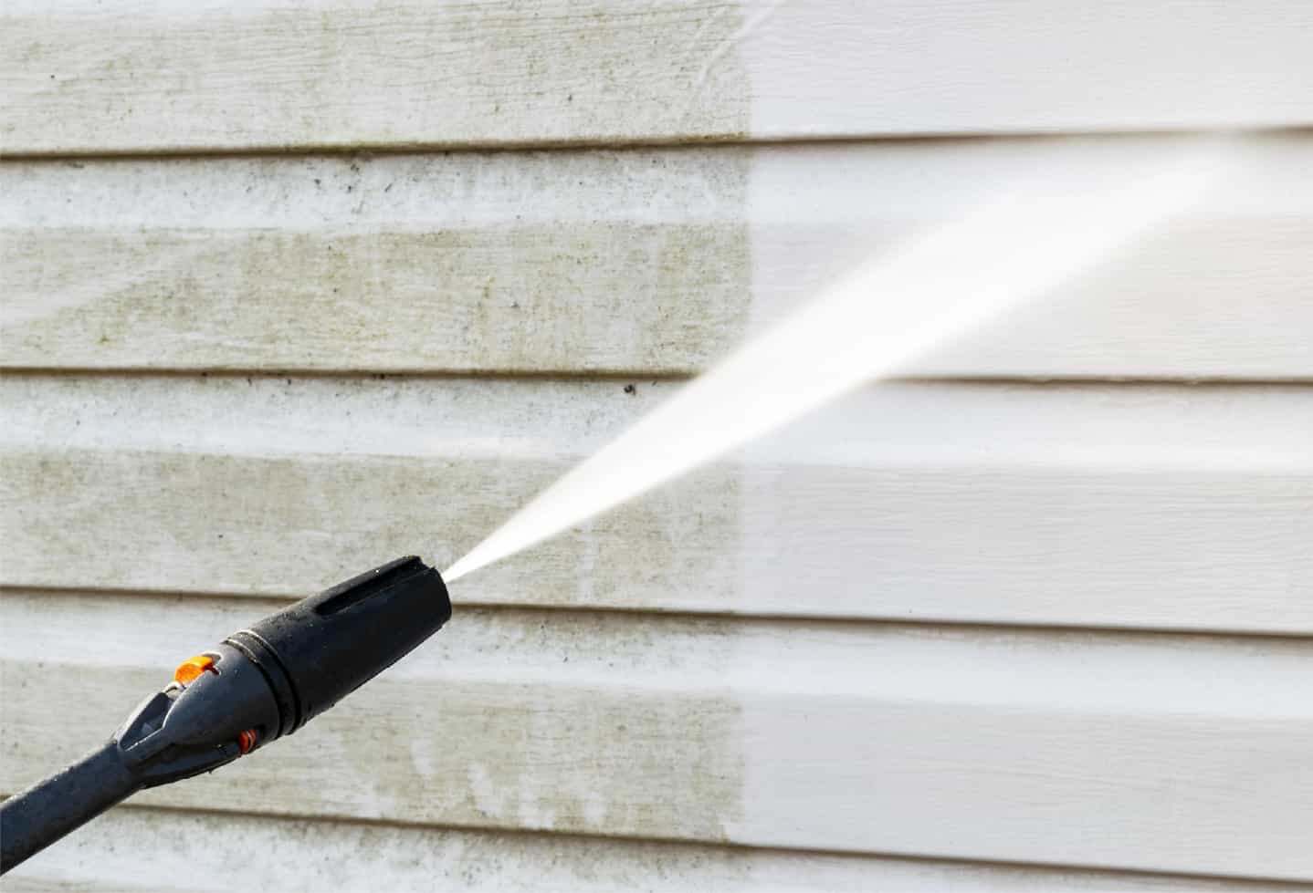 pressure power washing on wood siding of house