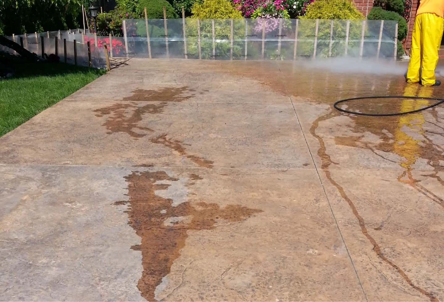 man power washing stone floor driveway