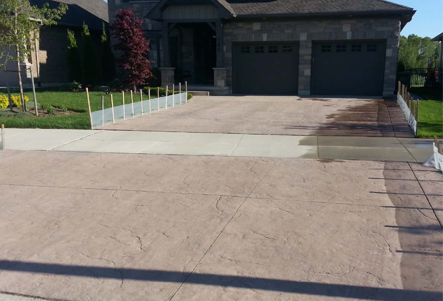 stone tile hardscape driveway of double garage power washed