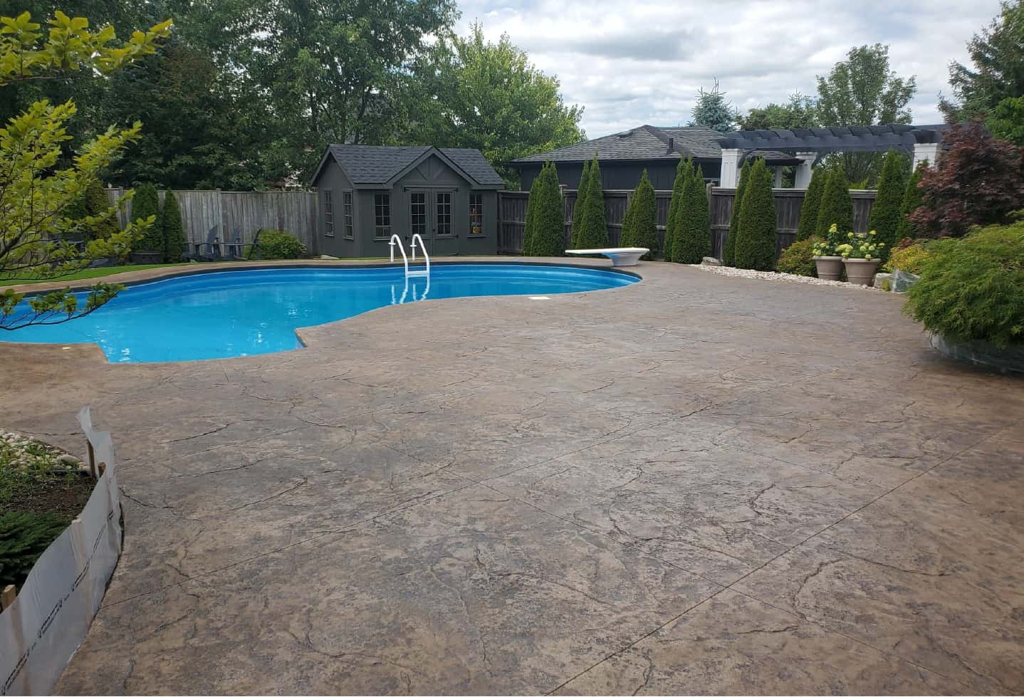 swimming pool with cement patio backyard