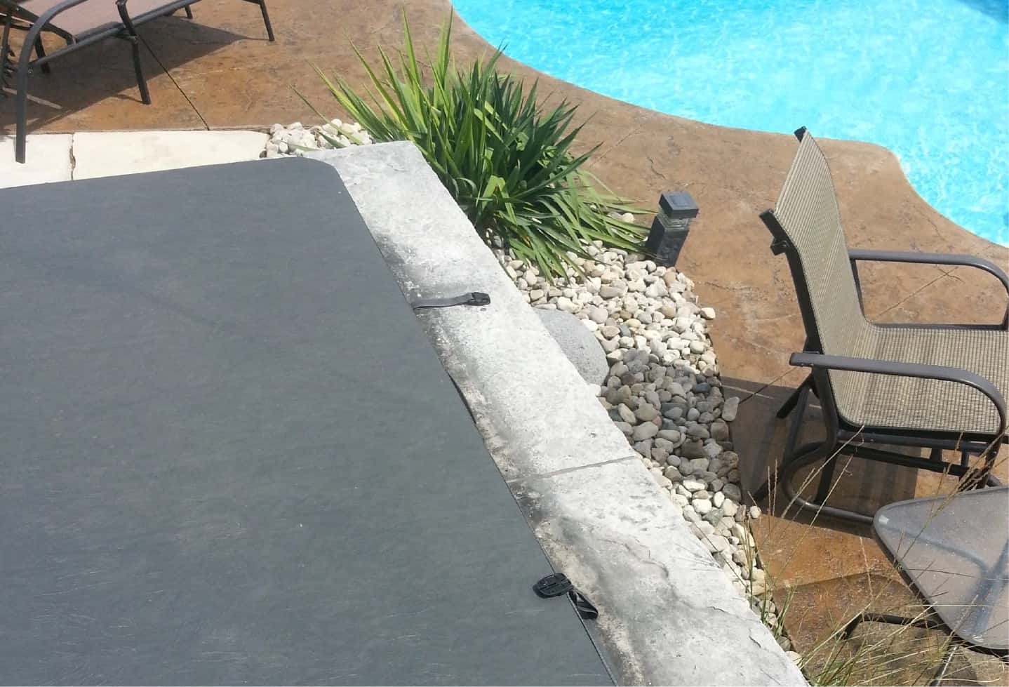 swimming pool with cement patio backyard