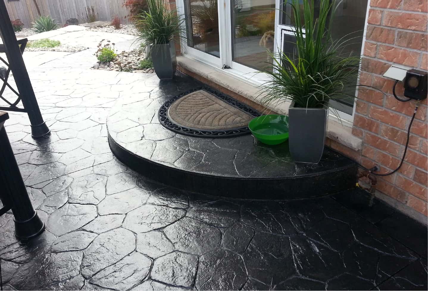 stone step of house and patio with stone tiles stained black