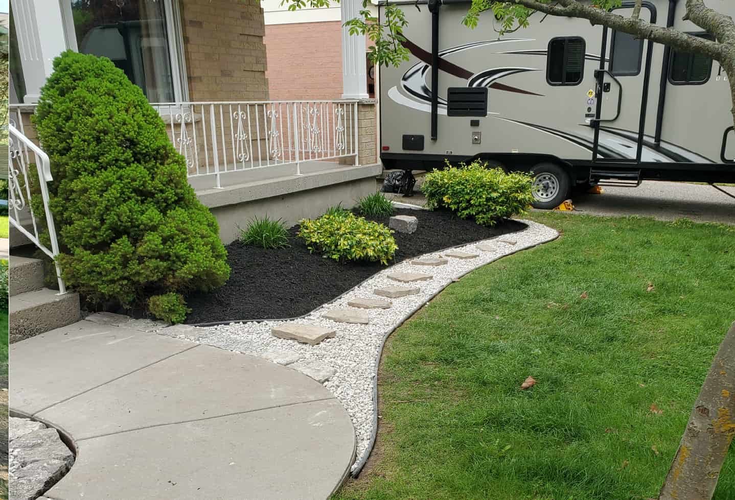 landscaping work detail bushes, plants grass in front of house