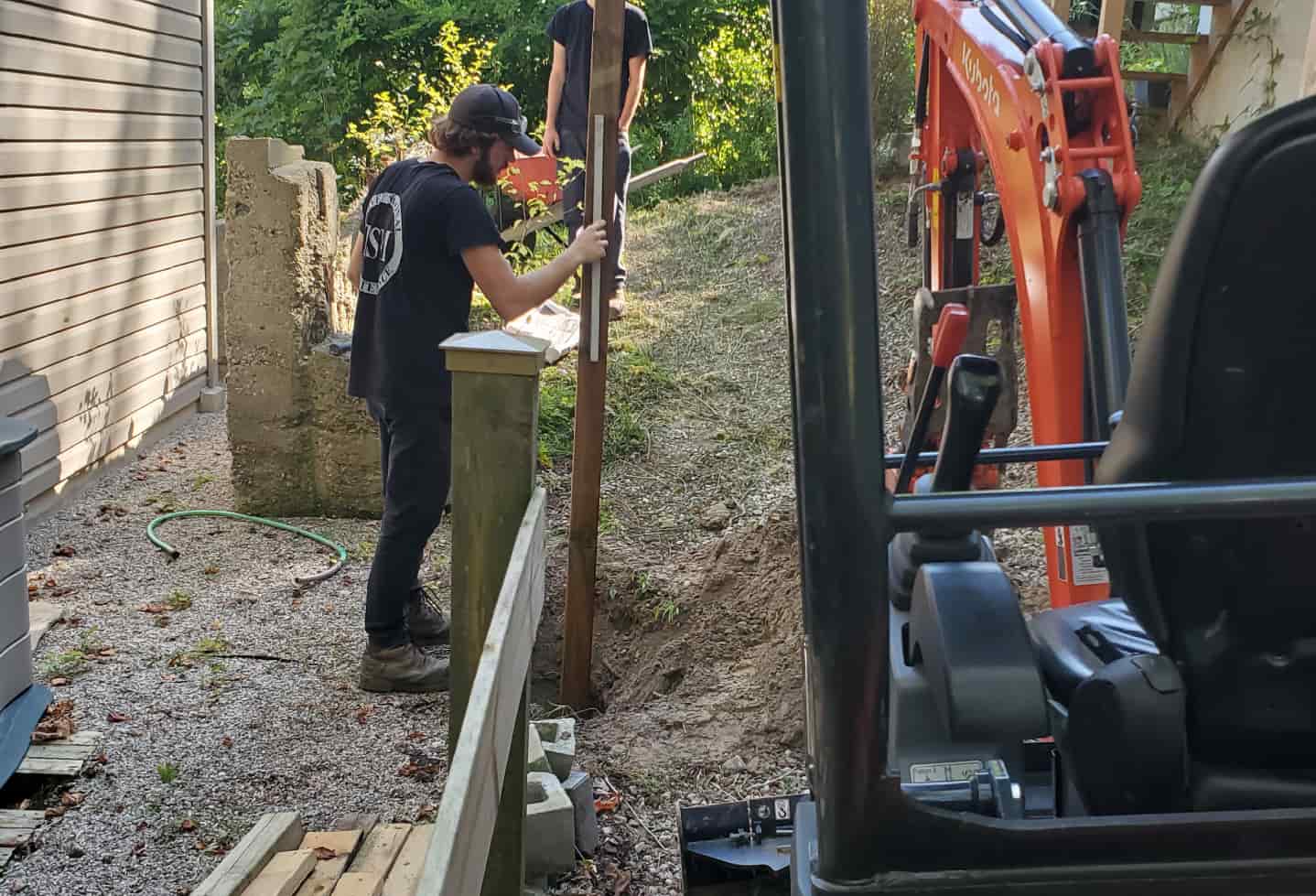 tradesman excavating near house