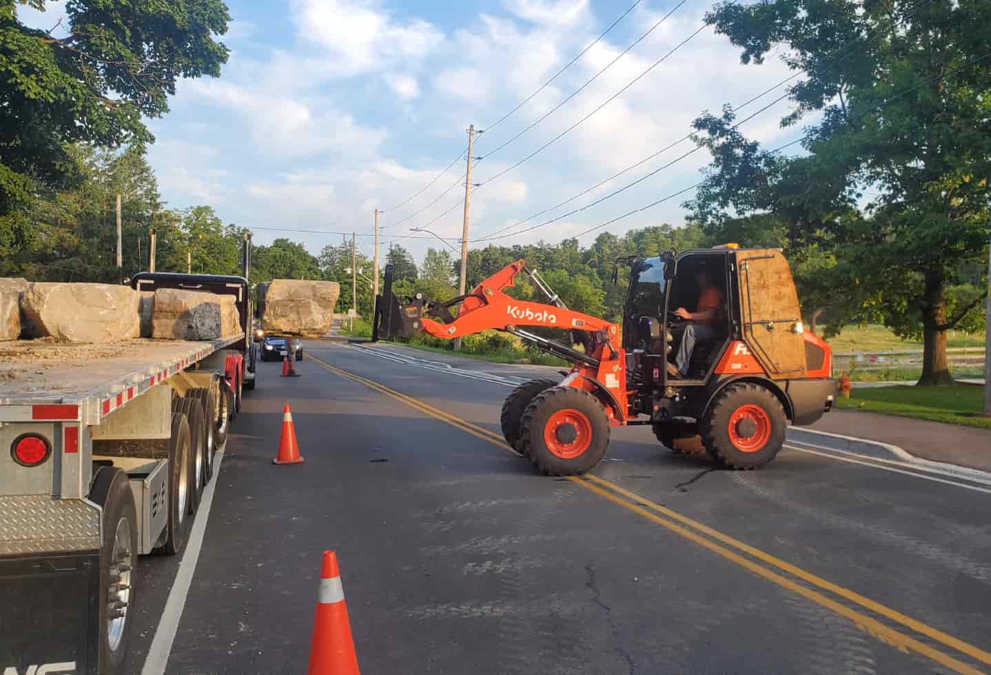 kabuto excavator on road with orange safety cones